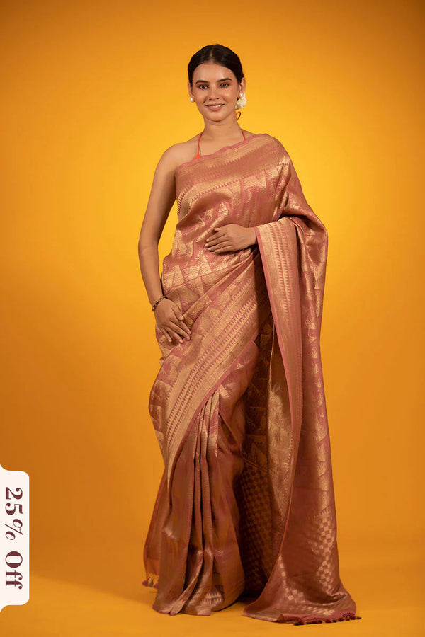 Woman wearing a bronze saree on an orange background with a discount label.