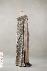 Black Banarasi Silk Saree with Pichwai cow woven pattern, draped on a mannequin against a plain background