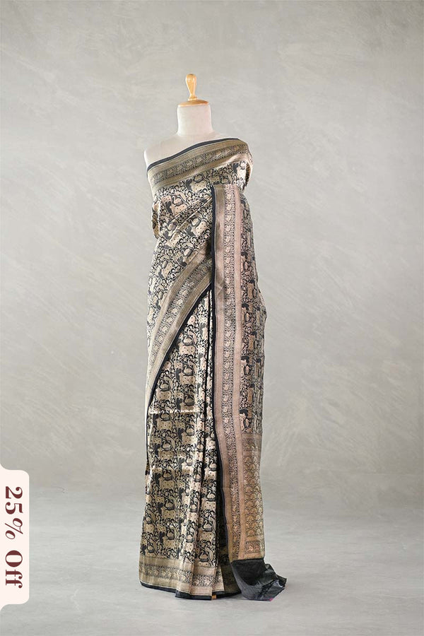 Black Banarasi Silk Saree with Pichwai cow woven pattern, draped on a mannequin against a plain background