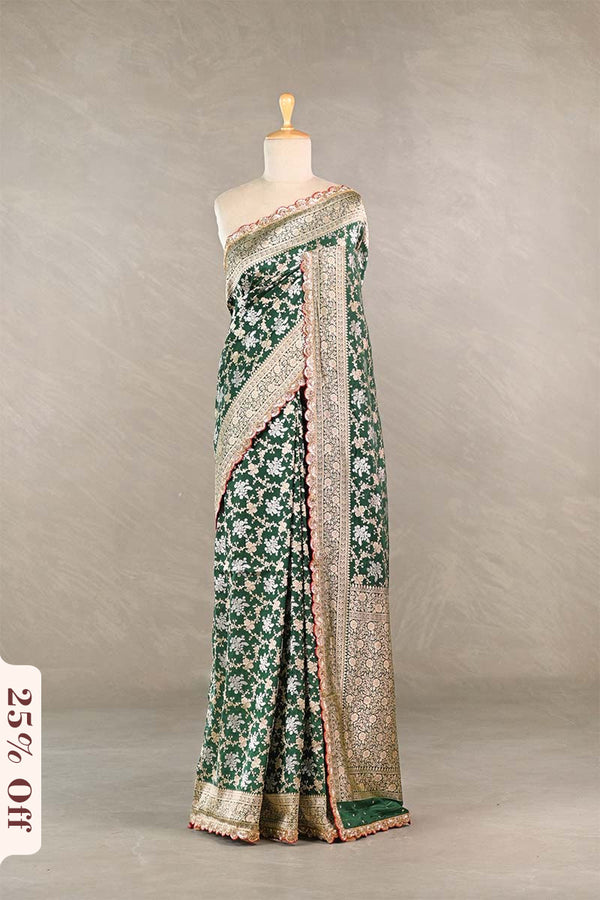 Green floral saree with a textured border on a mannequin against a neutral background