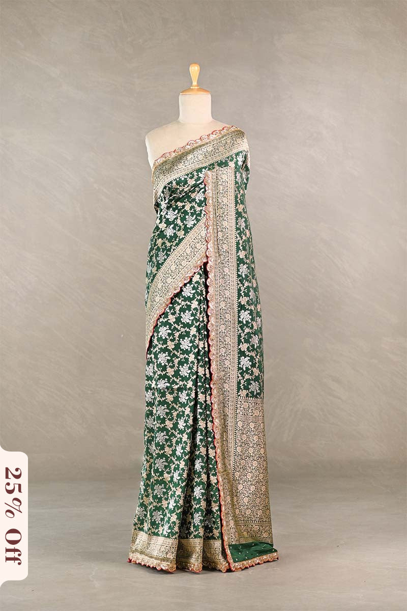 Green floral saree with a textured border on a mannequin against a neutral background