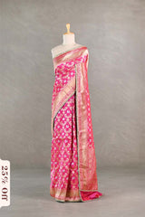 Pink saree with a floral pattern on a mannequin against a gray background
