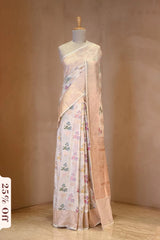 A White banarasi silk saree with multicolor floral work on dummy