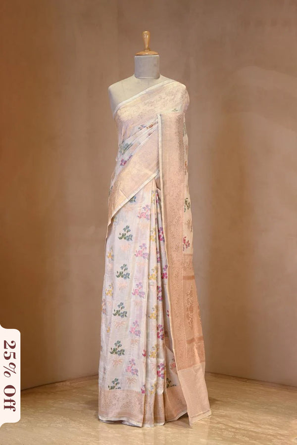 A White banarasi silk saree with multicolor floral work on dummy