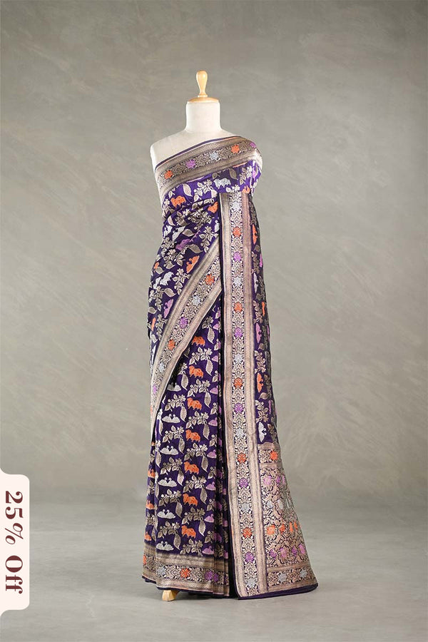 Red Banarasi silk saree with light gold intricate Pichwai woven patterns draped on a mannequin against a gray background