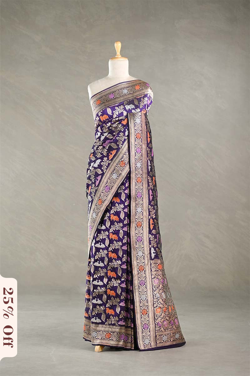 Red Banarasi silk saree with light gold intricate Pichwai woven patterns draped on a mannequin against a gray background