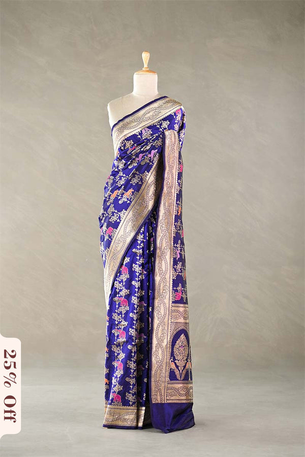 Blue silk saree with floral patterns on a mannequin against a neutral background