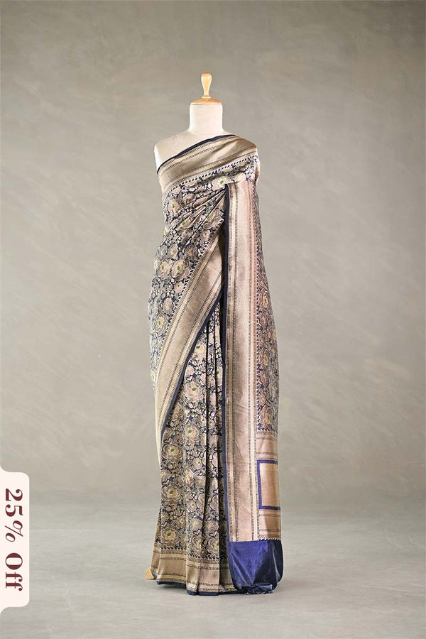 Navy Blue Banarasi silk saree with light gold intricate woven patterns draped on a mannequin against a gray background