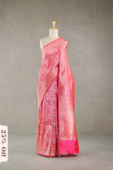 Pink silk saree with intricate patterns on a mannequin against a gray background