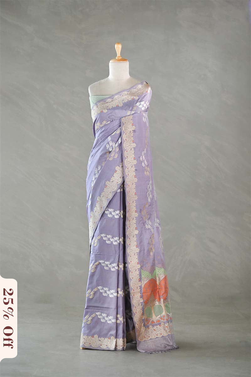 Lavender saree with floral patterns on a mannequin against a gray background