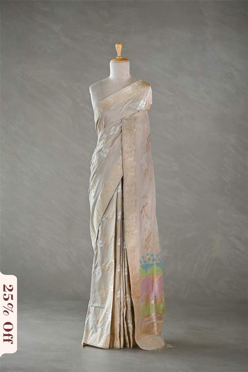 Saree on a mannequin against a gray background with a discount label.