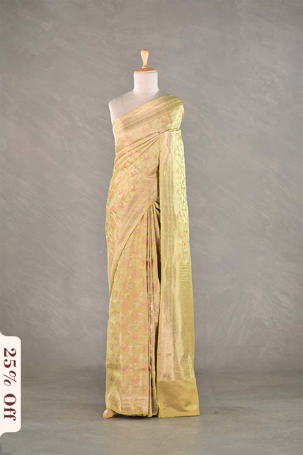 Light green saree on a mannequin against a gray background with a discount label.