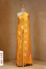A yellow Banarasi silk saree on dummy