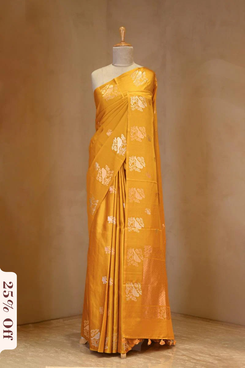 A yellow Banarasi silk saree on dummy
