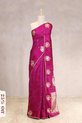 Pink saree with floral patterns on a mannequin against a plain background