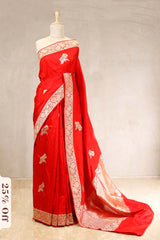 Red saree with white embroidery on a mannequin against a neutral background