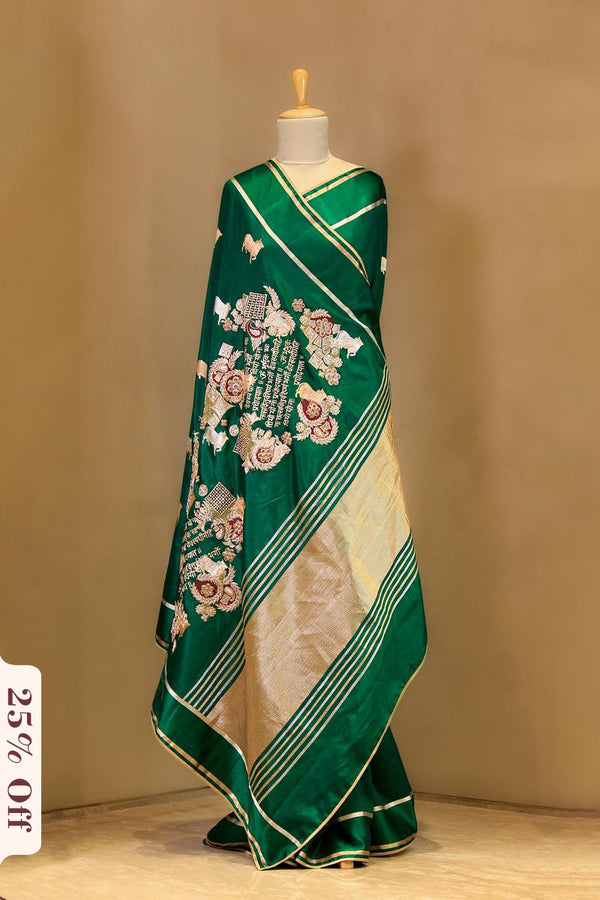 Green and white saree with floral patterns on a mannequin against a beige background