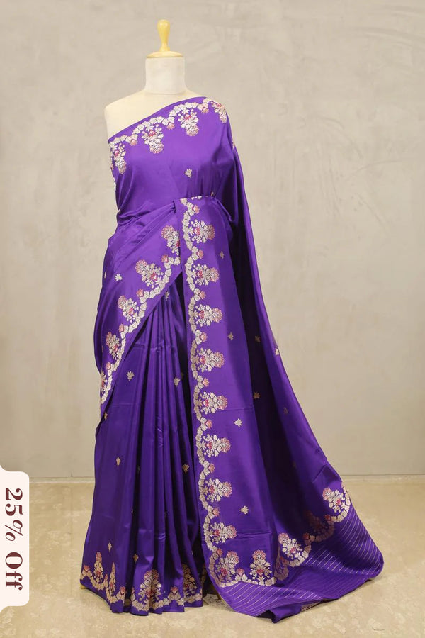 Purple saree with floral patterns on a mannequin against a plain background