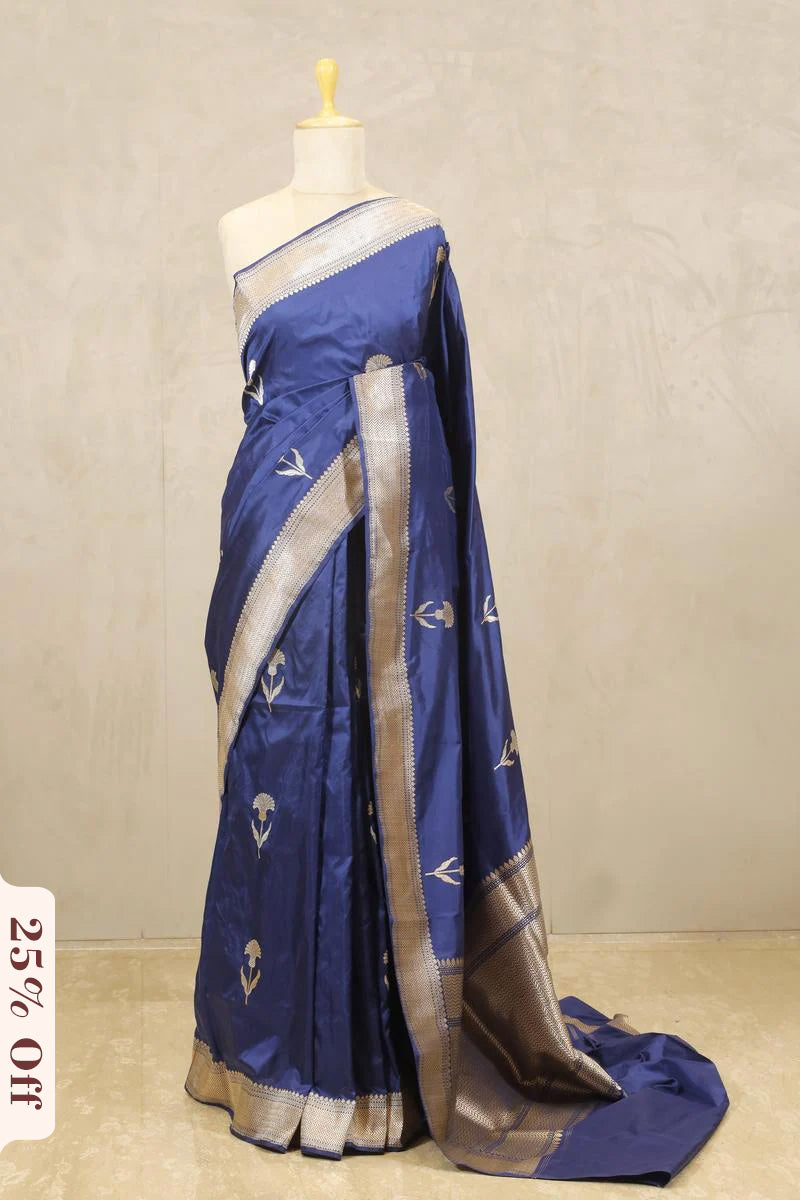 Blue saree with white patterns on a mannequin against a beige background