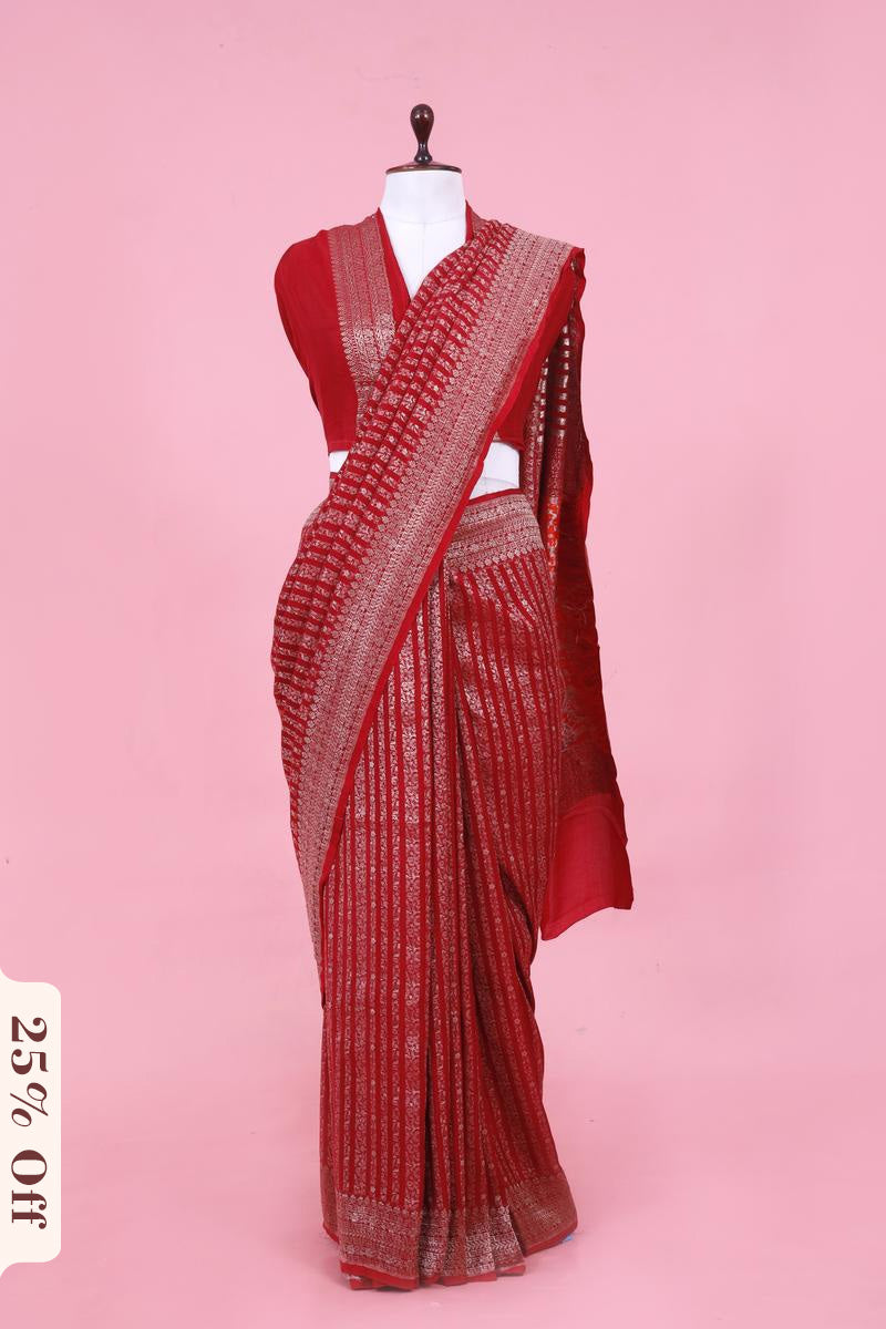 Red saree with white patterns on a pink background