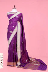 Purple saree with white patterns on a mannequin against a pink background