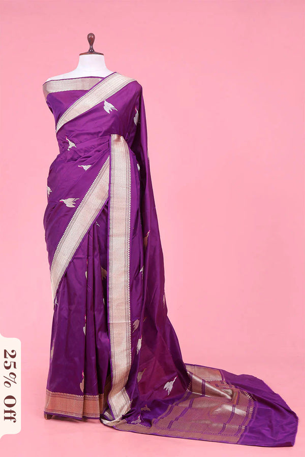 Purple saree with white patterns on a mannequin against a pink background