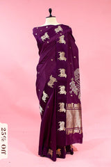 Purple saree with elephant patterns on a mannequin against a pink background