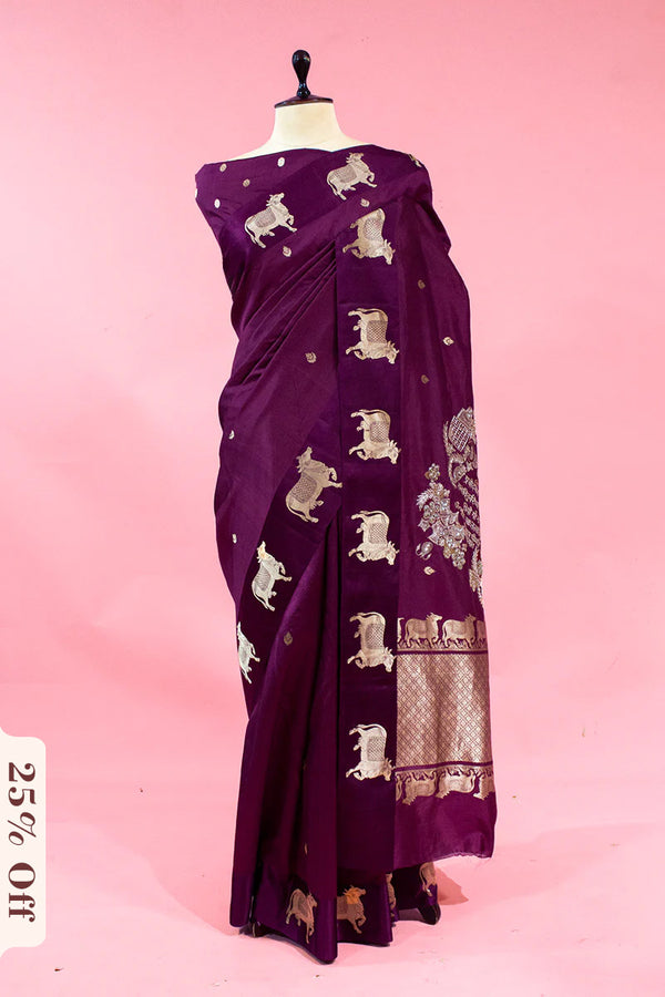 Purple saree with elephant patterns on a mannequin against a pink background
