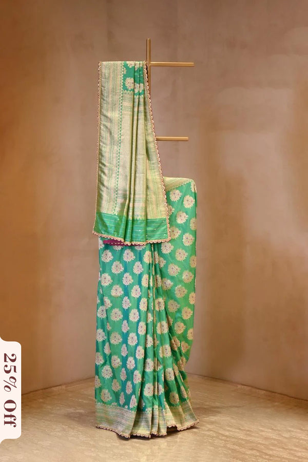 A sea green Banarasi silk saree with zari motifs on dummy