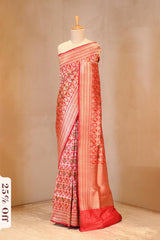 A red shikargah Banarasi silk saree on dummy