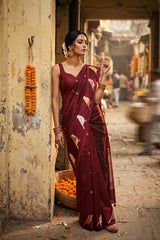 Women wearing a maroon silk saree draped like Nita Ambani style on a mannequin