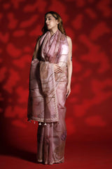 Woman wearing a pink saree with a red background