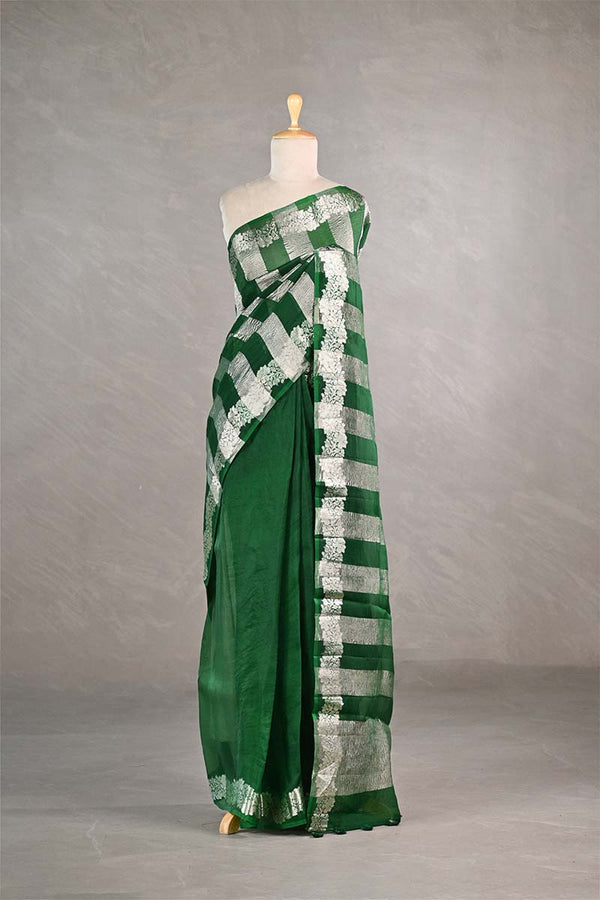 Green and white checkered saree on a mannequin against a gray background