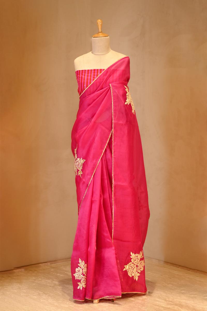 A pink organza silk saree on dummy