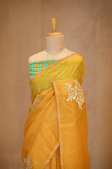 A Yellow organza silk Saree on dummy