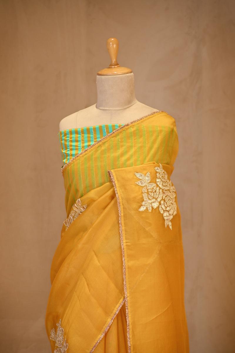 A Yellow organza silk Saree on dummy