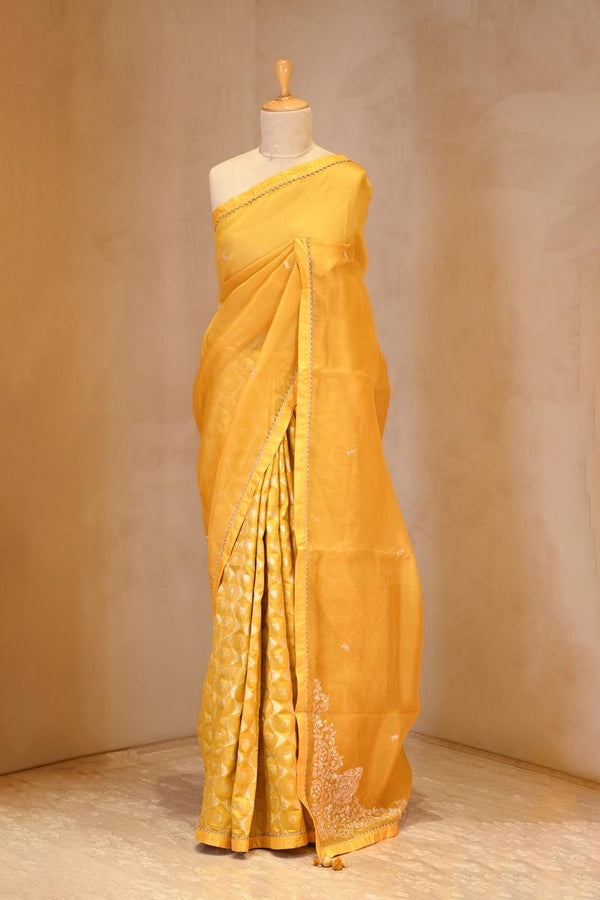 A yellow organza saree on dummy