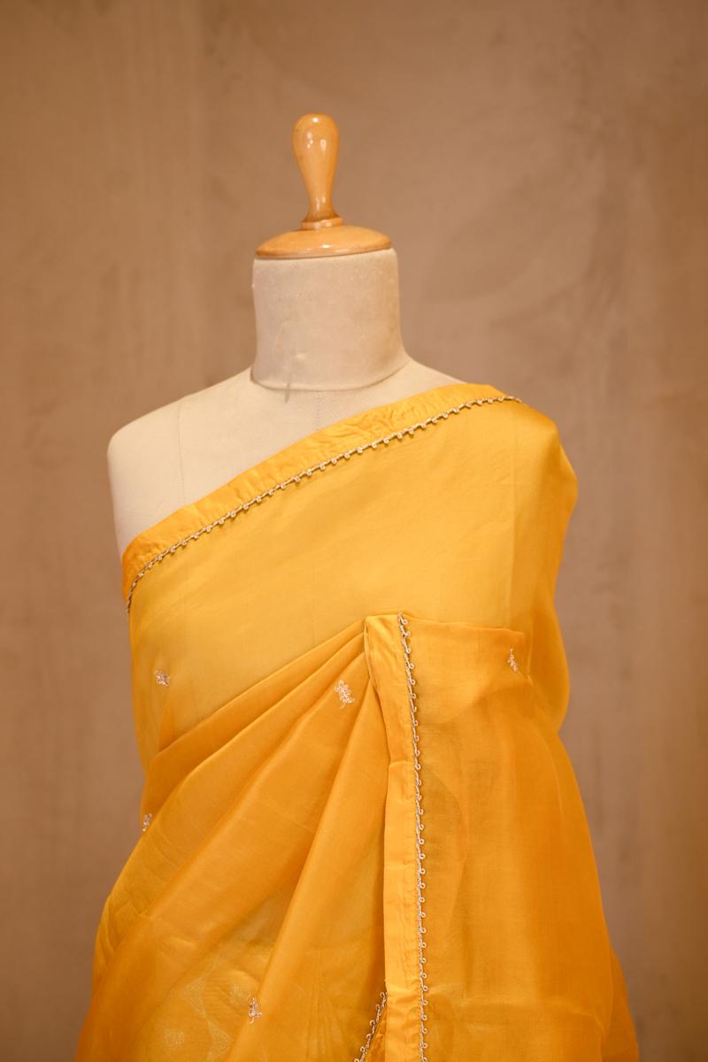 A yellow organza saree on dummy