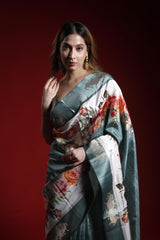 Woman wearing a floral saree against a red background