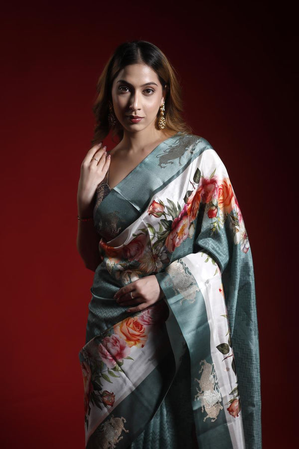 Woman wearing a floral saree against a red background