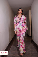 Woman in a colorful outfit standing in a hallway with a 40% off sign in the corner.