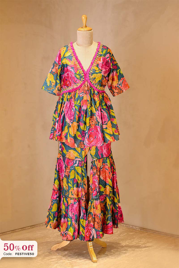 A colorful floral dress on a mannequin against a beige background with a 50% Diwali offer label