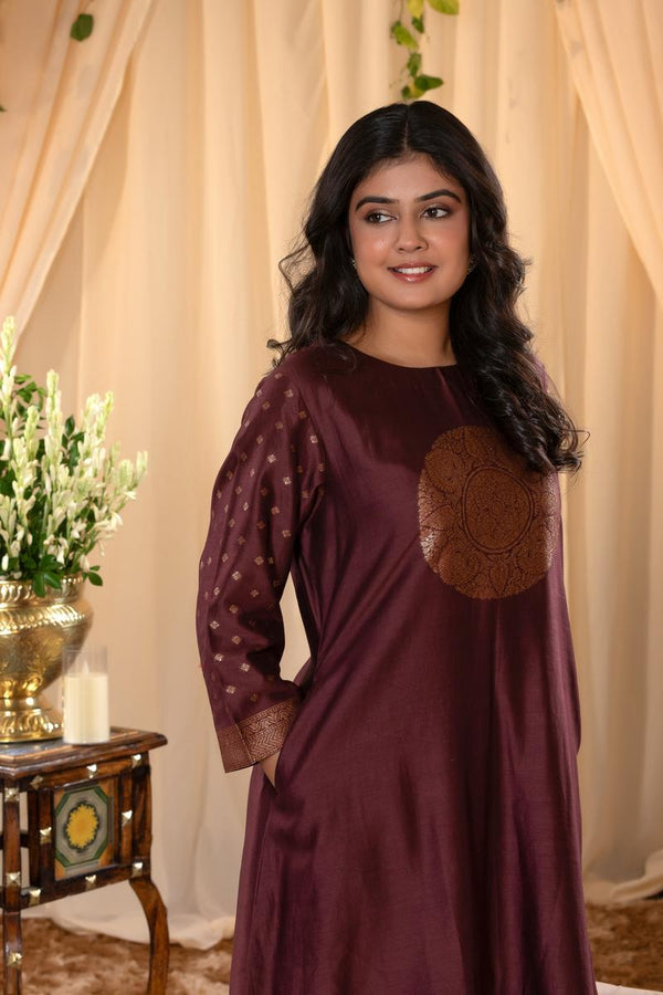 A woman in a brown traditional Kurti co-ord set standing. brown Wedding Kurti Salwar Suit 