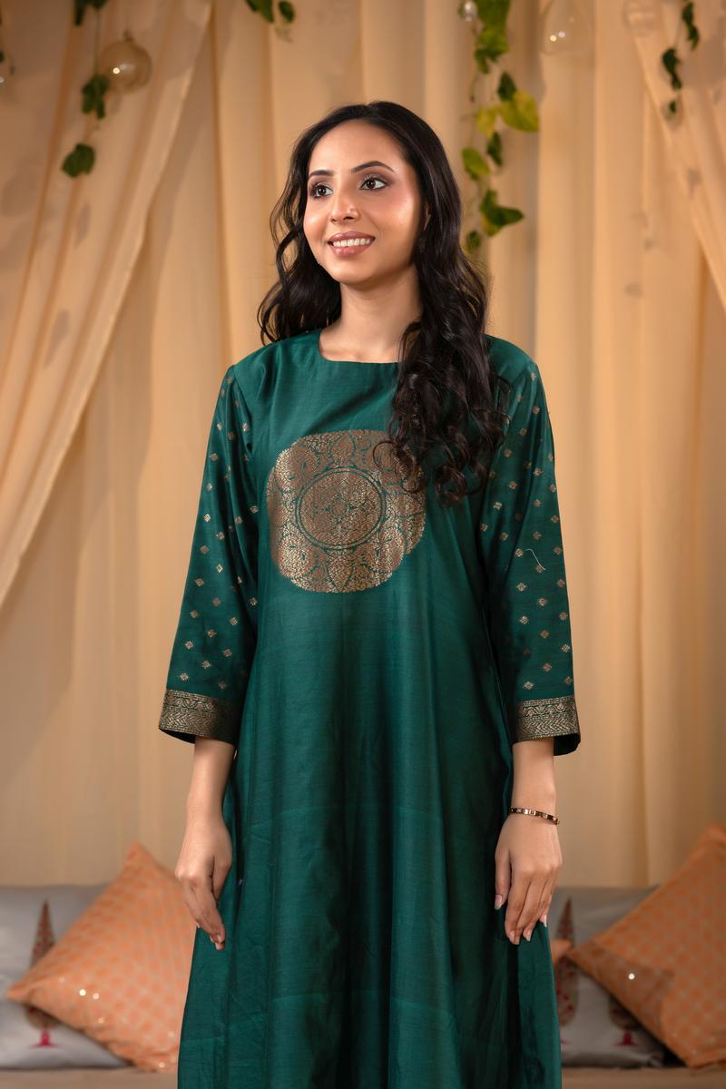 A woman in a green traditional Kurti co-ord set standing. green Wedding Kurti Salwar Suit 