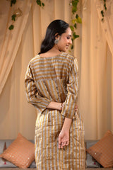 A woman in a traditional Kurti made with golden Tissue Silk Fabric for party wear looks like Deepika Padukone