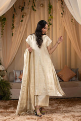 A woman in a traditional off white salwar suit and off white banarasi dupatta 