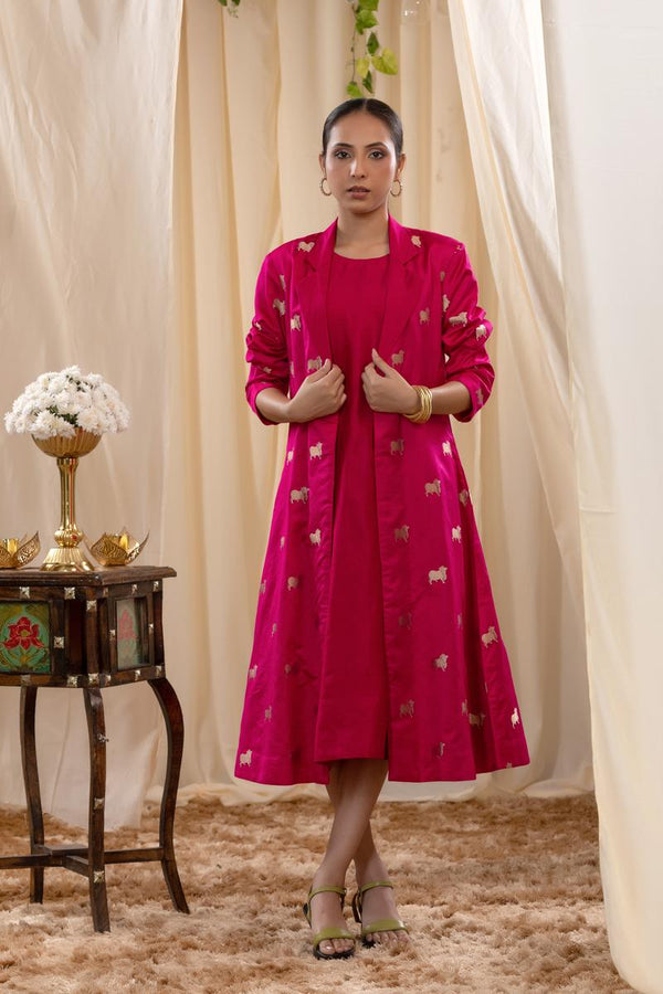 A woman in a pink Indo-Western dress, paired with a matching coat featuring pichwai motifs.