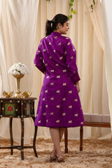A woman in a purple Indo-Western dress, paired with a matching coat featuring pichwai motifs.