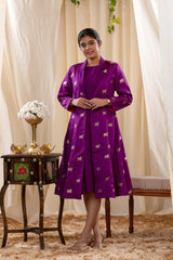 A woman in a purple Indo-Western dress, paired with a matching coat featuring pichwai motifs.