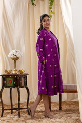 A woman in a purple Indo-Western dress, paired with a matching coat featuring pichwai motifs.